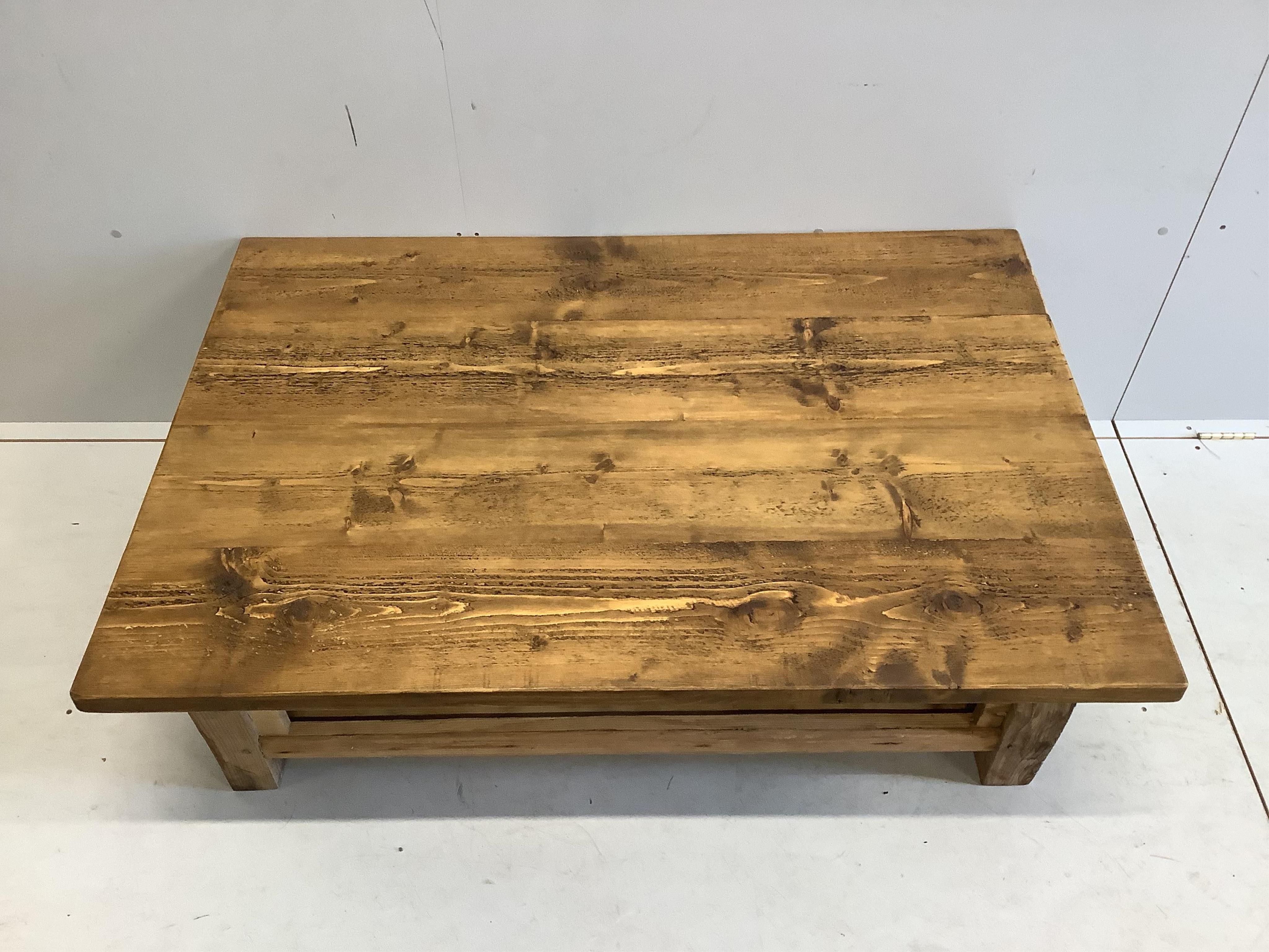 A rectangular pine two tier coffee table, width 129cm, depth 88cm, height 46cm. Condition - good